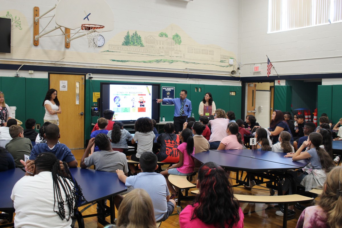 Students in assembly listening to presentation